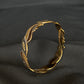 22K Gold Bangle with Flowing Two-Tone Design.