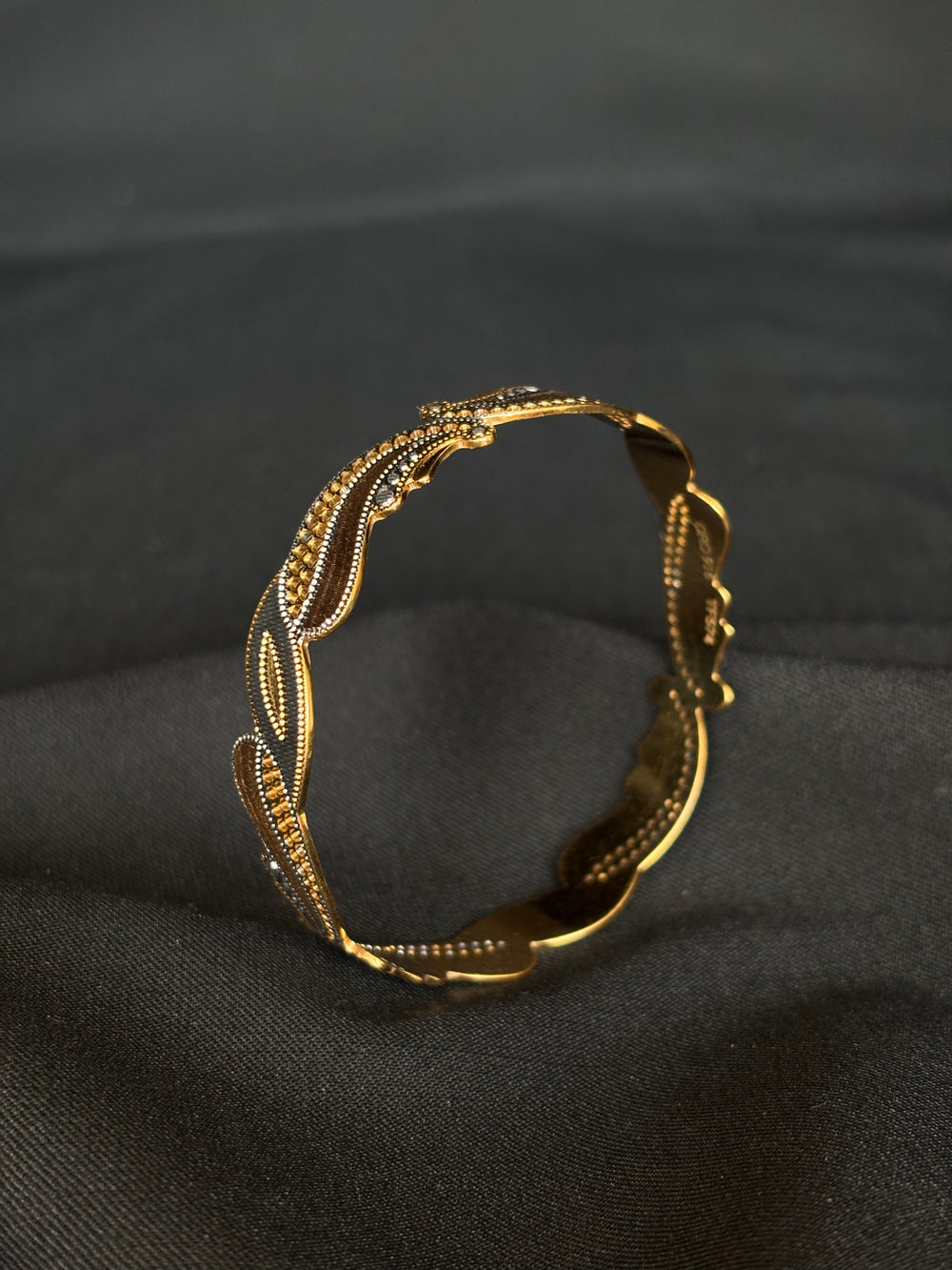 22KT Gold Bangle with Flowing Two-Tone Design.