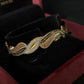 22K Gold Bangle with Flowing Two-Tone Design.
