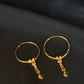 Elegant 22K Gold Hoop Earrings with Dangling Pendant Details.