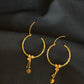 Elegant 22K Gold Hoop Earrings with Dangling Pendant Details.