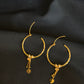 Elegant 22K Gold Hoop Earrings with Dangling Pendant Details.