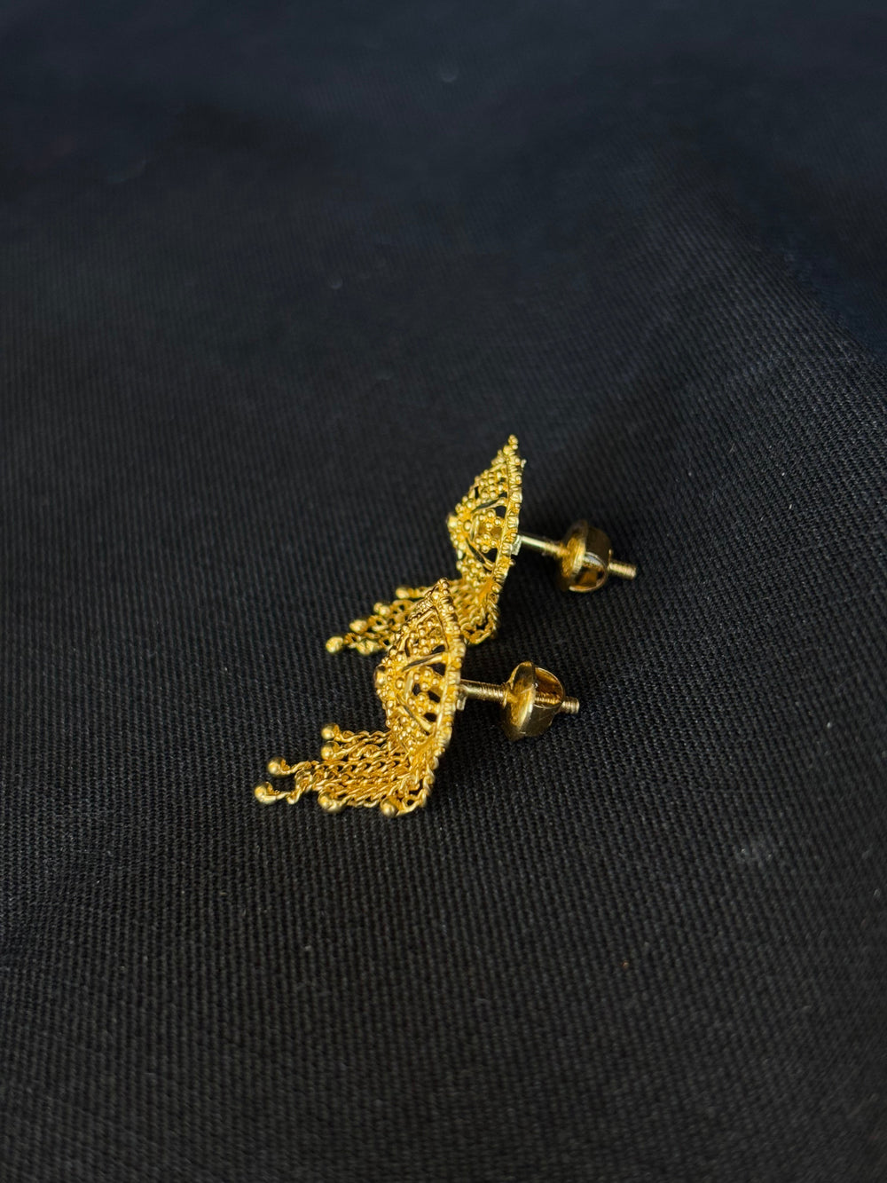 22KT Gold Stud Earrings with Dangling Chain Details.