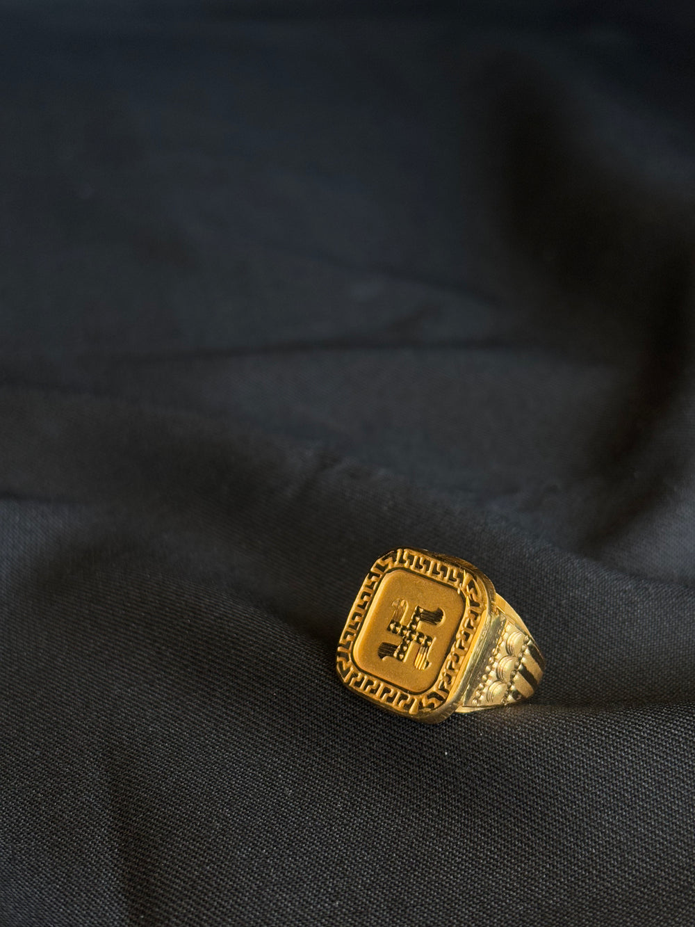 22K Gold Gents Ring with Swastik Symbol & Patterned Border.