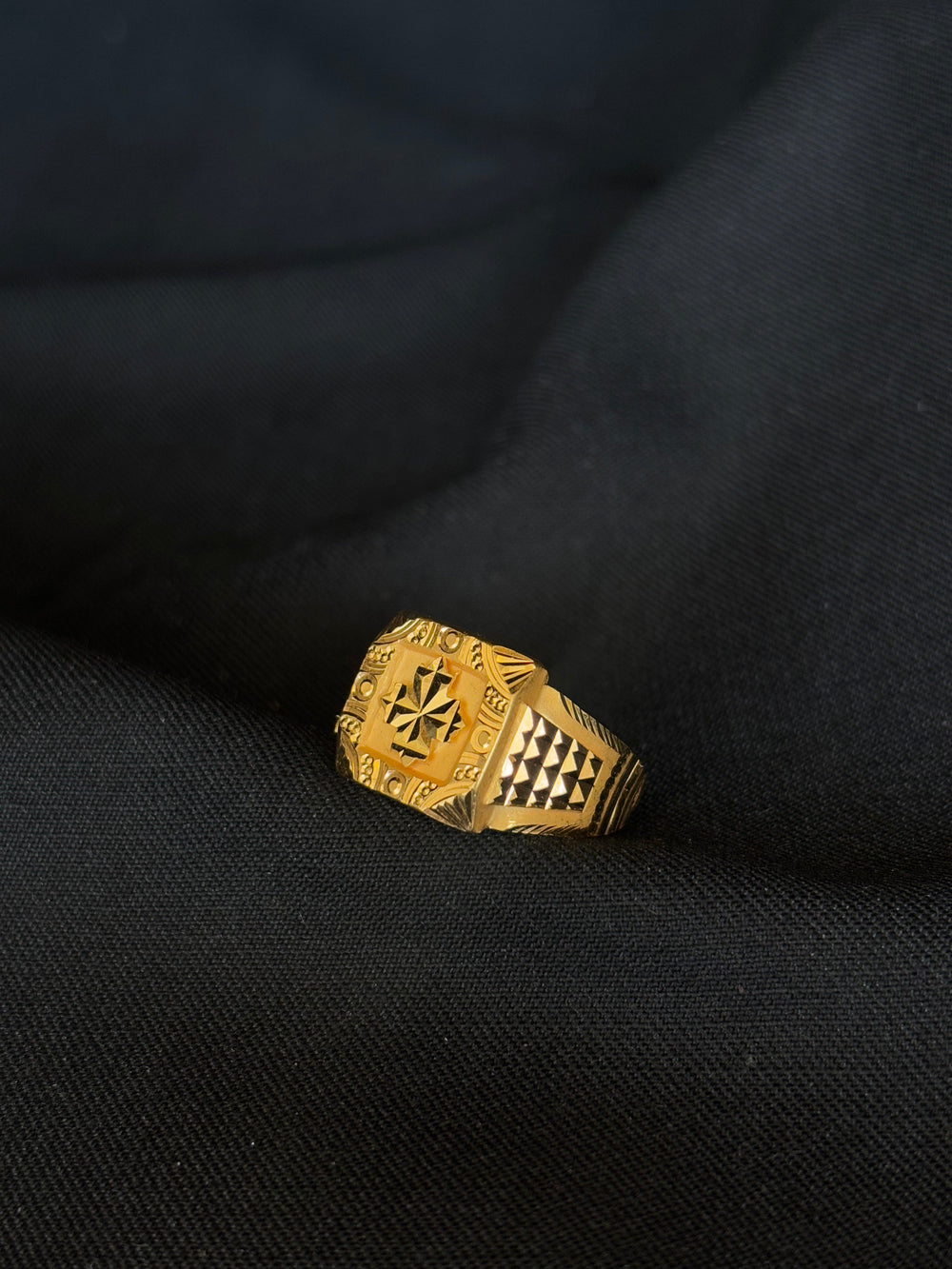 22KT Gold Gents Ring with Distinctive Central Design & Patterned Band.